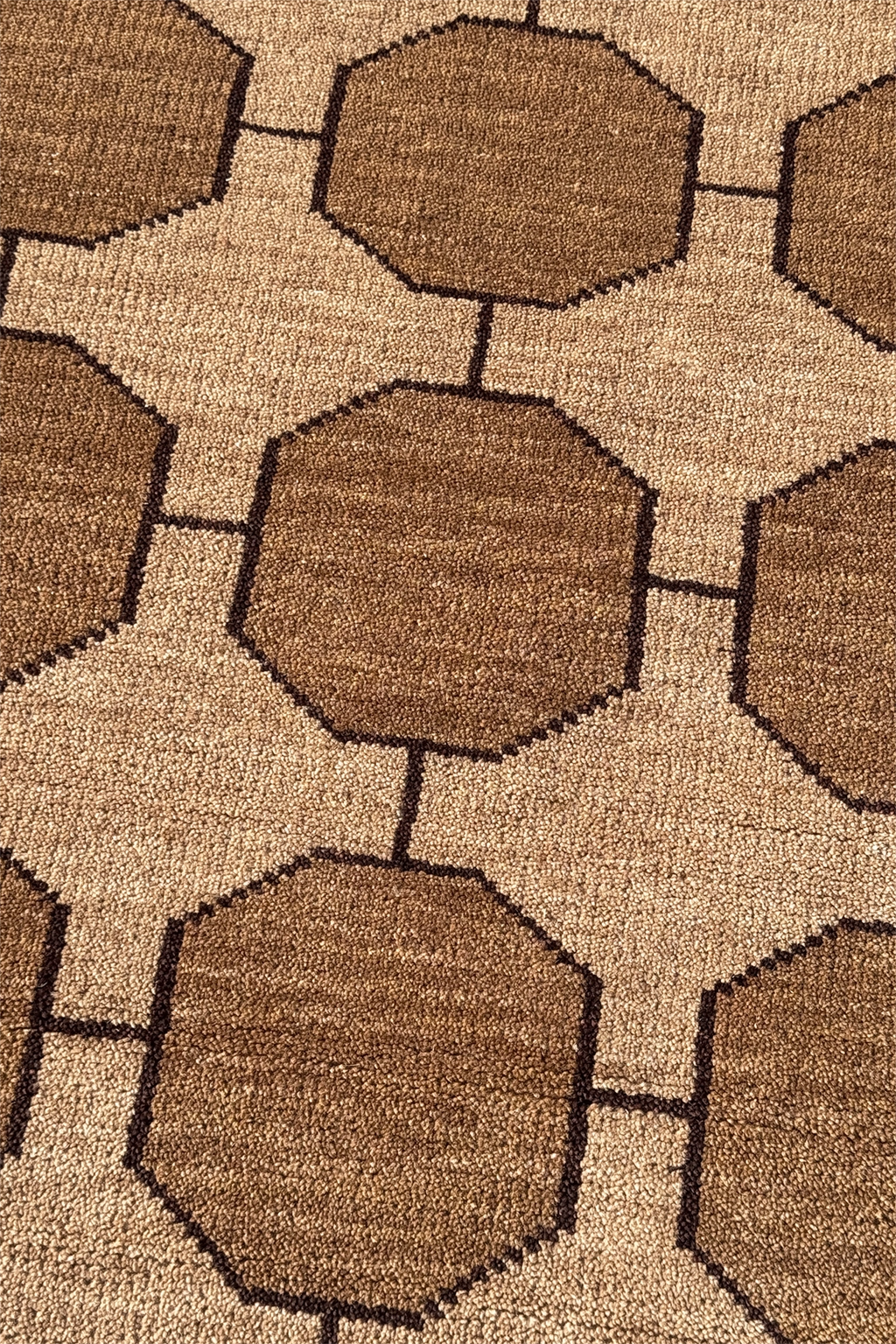 Close-up of a light tan taupe geometric patterned rug