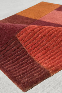 Textured terracotta wool area rug with soft block pattern, handmade luxury rug for warm-toned interiors
