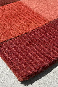 Terracotta block tufted wool runner rug with deep warm shades, ideal for hallway or bedside