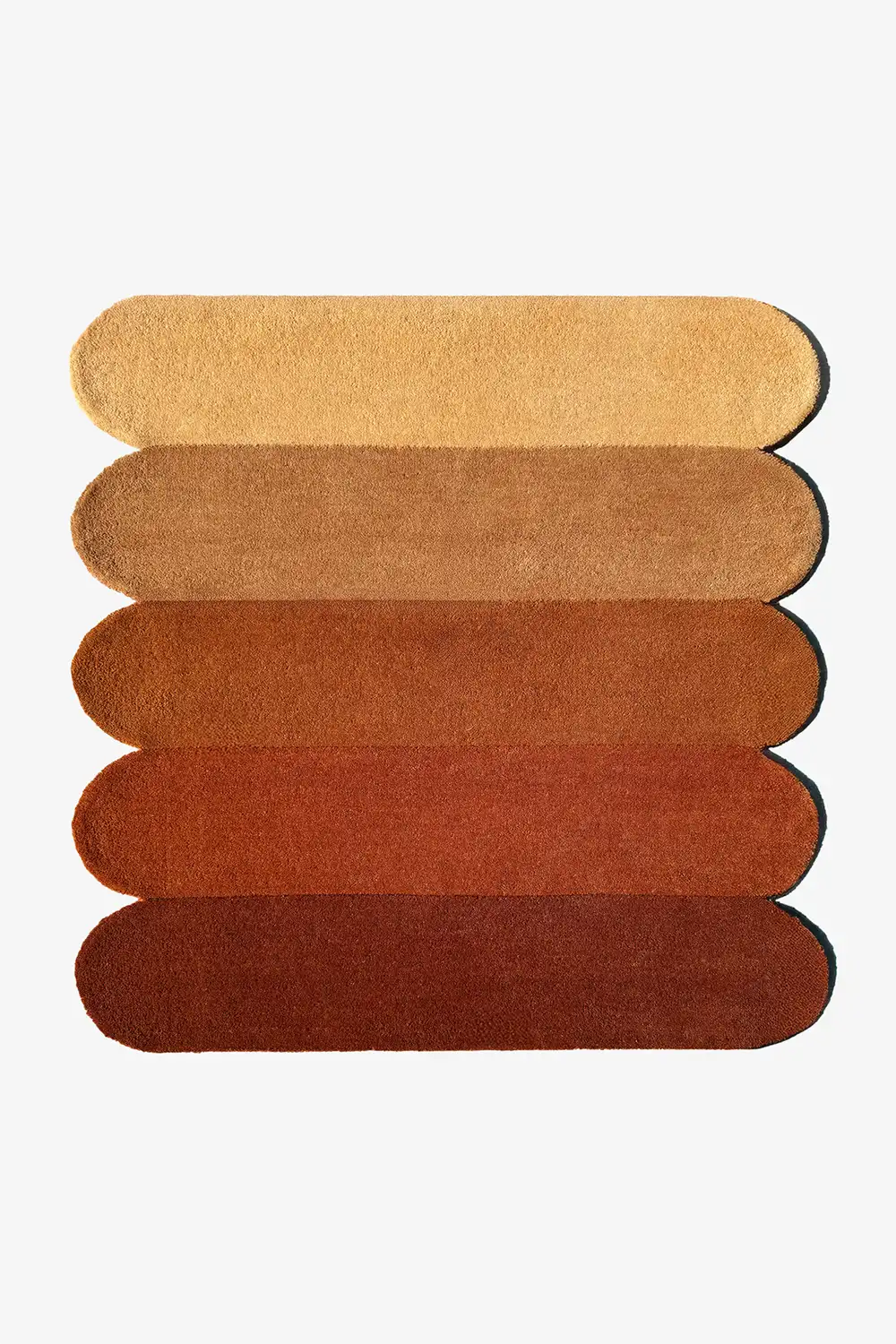 Rug with horizontal stripes in brown and orange shades and scalloped sides on a white background