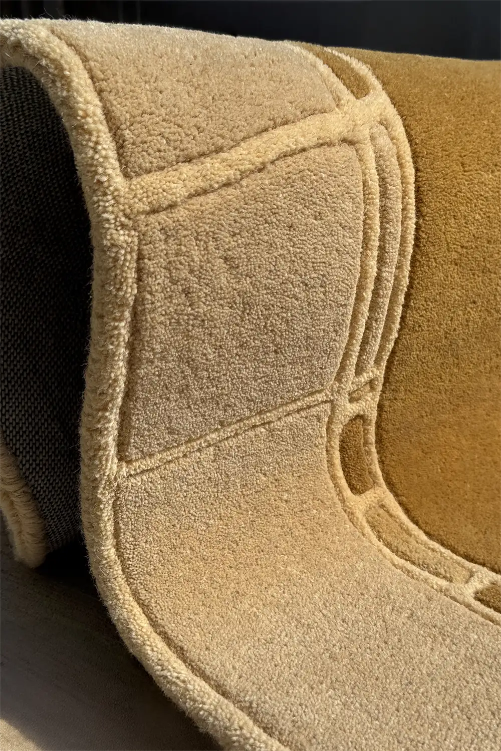 Intersecting square and line motif on sculptural taupe and gold arched rug, perfect for unique living room rug styling