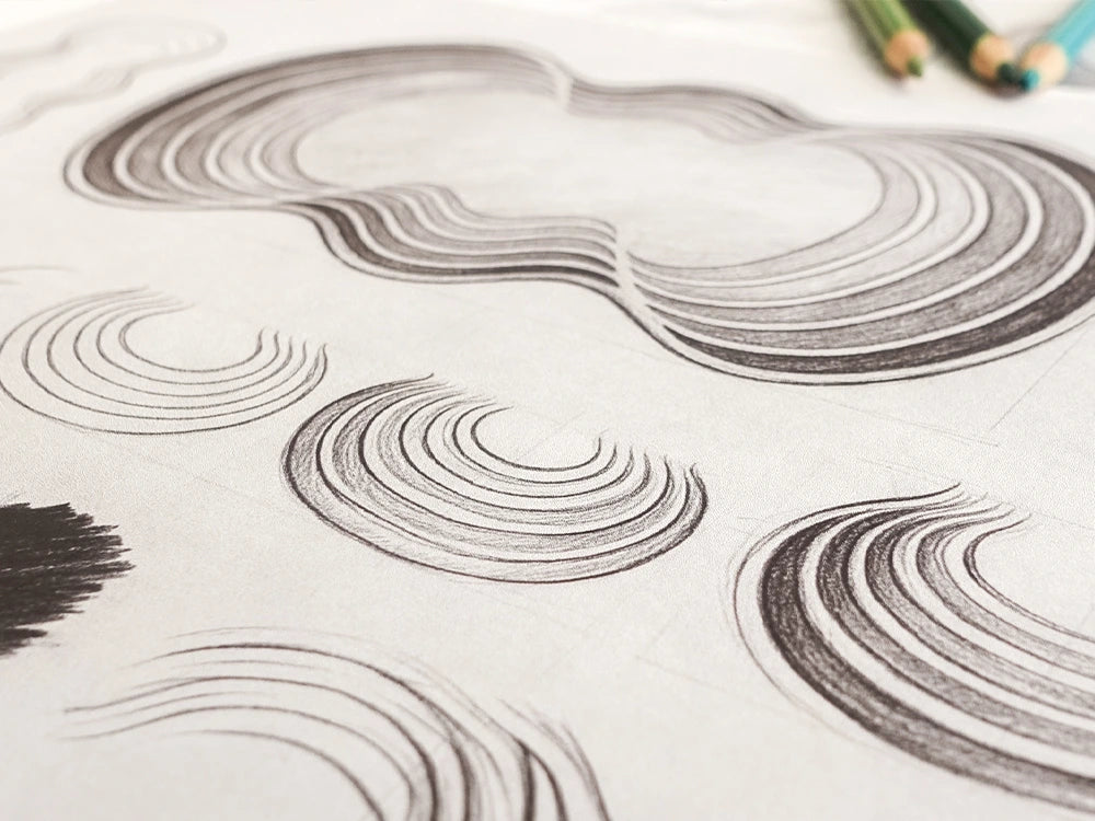 Pencil design sketches for the Undula hand-tufted wool rug, showing nested concentric curves flowing into soft, irregular wave shapes.