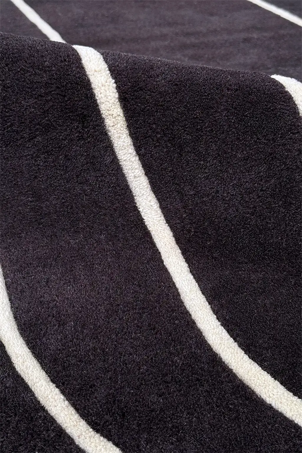 close up texture of black and white runner rug with thin stripes
