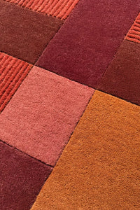 Warm burgundy, rust, and brown wool tufted rug with tonal blocks, cozy accent rug for small living spaces
