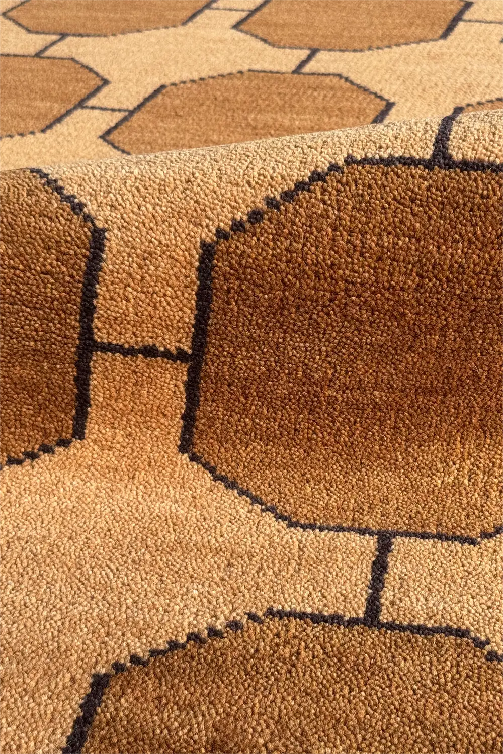 Close-up of a gold brown modern textured rug with geometric pattern