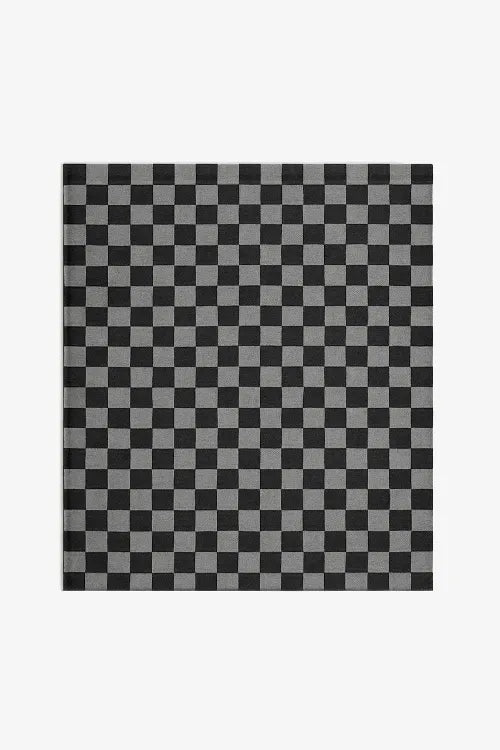 flatweave rug with a checkered pattern in black and gray on a white background
