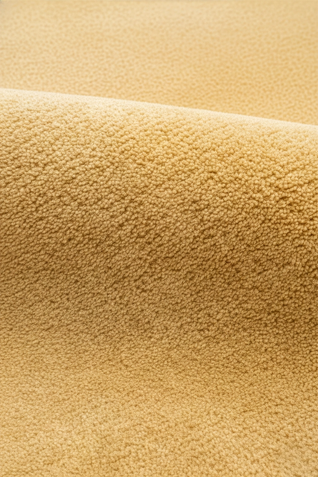 close-up texture of light yellow round wool rug hand tufted