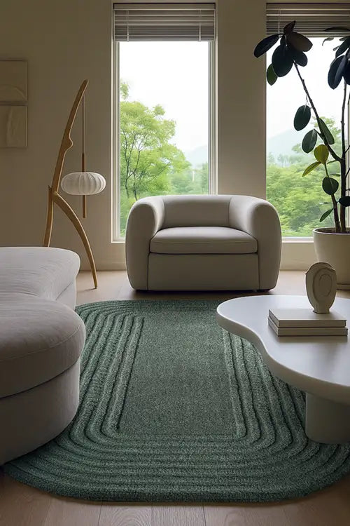 Modern living room with a green rug, beige armchair, and white coffee table.