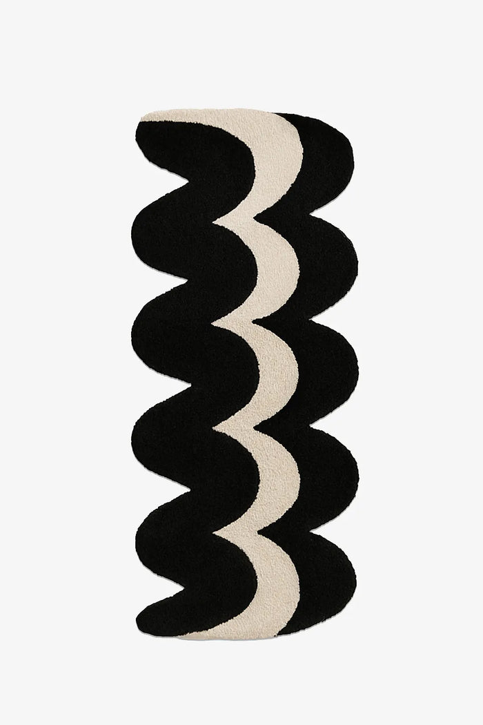 unique runner rug with black and beige wavy pattern on a white background