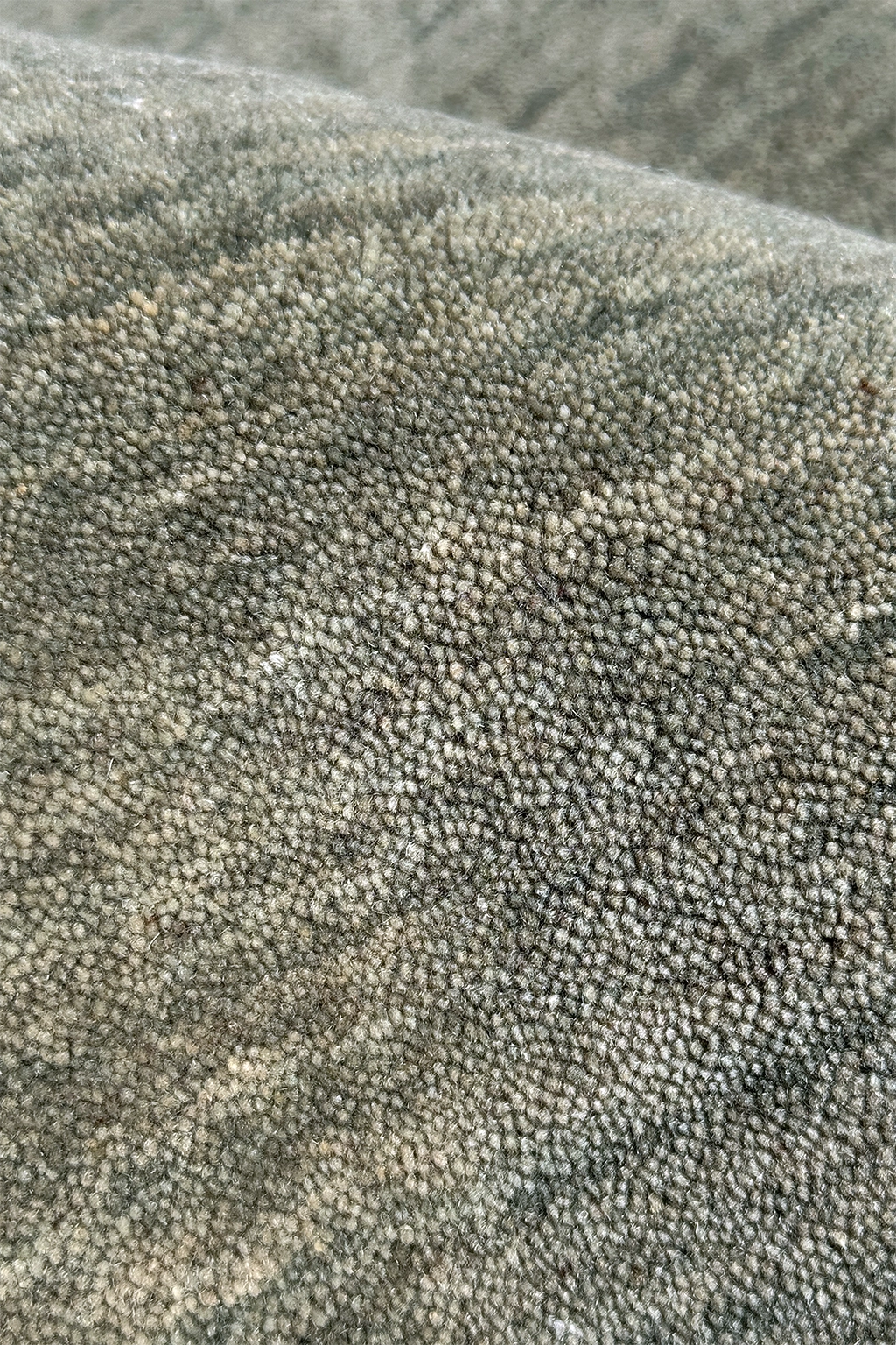 Close-up of a sage green runner rug hand loomed in wool texture