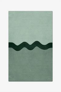 Rectangular green rug with wavy black line design on a white background
