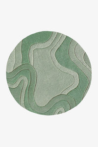 A round area rug featuring an abstract, topographic-like pattern of wavy contour lines in various shades of sage green  on a white background.