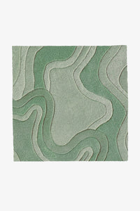 A square area rug with an abstract, layered topographic design in shades of sage green and light gray, shown flat against a plain white background.