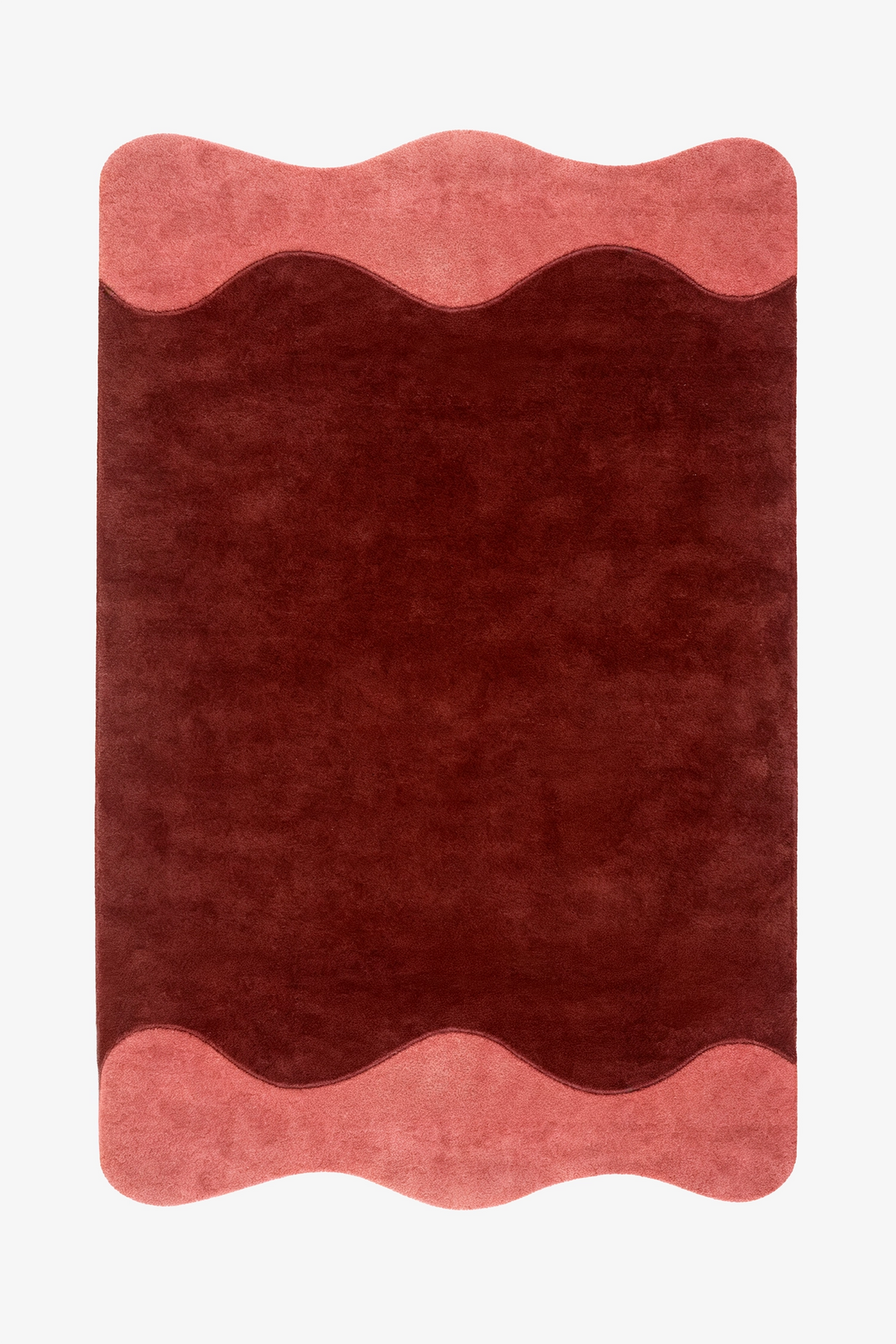 A rectangular area rug with a wavy scalloped border, featuring a deep burgundy rust  center and dusty salmon pink borders on the top and bottom, shown flat against a white background.