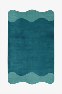 A rectangular area rug with a wavy pattern, featuring a dark teal center bordered by two lighter teal sections at the top and bottom, shown on a plain white background.