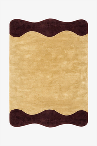 A rectangular area rug with a wavy scalloped border, featuring a textured yellow center and dark brown wavy top and bottom borders, shown flat against a plain white background.