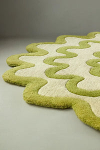 Side angle of a lime green and ivory scalloped wool rug, irregular coastal-inspired design lifestyle