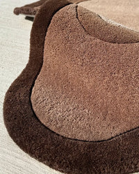 Soft brown and dark chocolate wavy wool rug with sculptural shape, modern handmade rug for neutral interiors