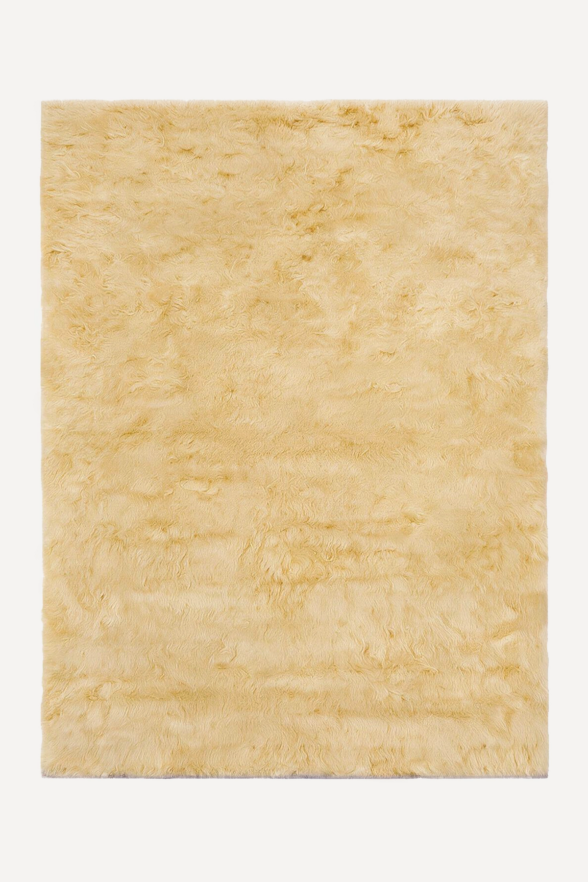 A rectangular shaggy rug in a light pale yellow color, shown flat against a solid white background.