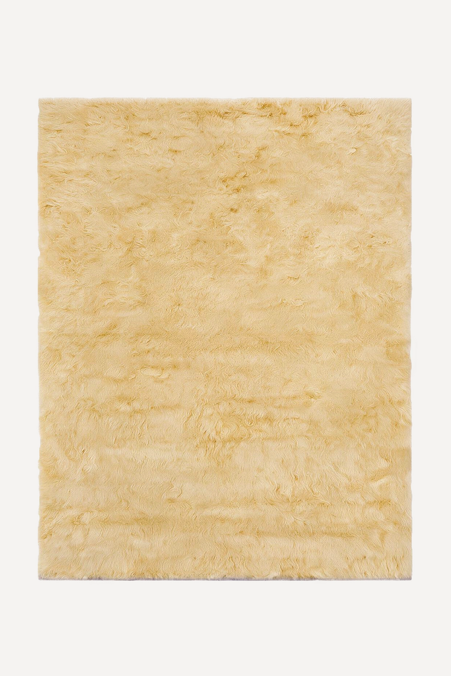 A rectangular pale yellow shag rug with a fluffy, high-pile texture, shown flat against a clean white background.