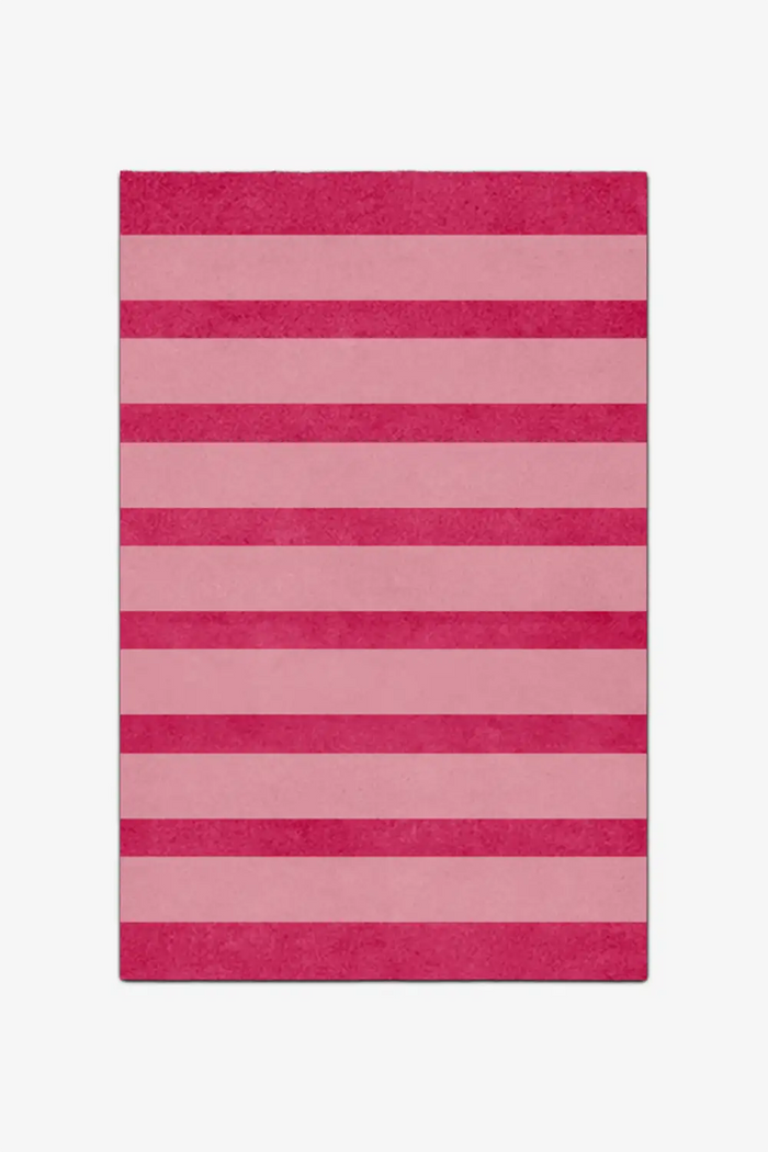Rectangular pink and red striped rug on a white background