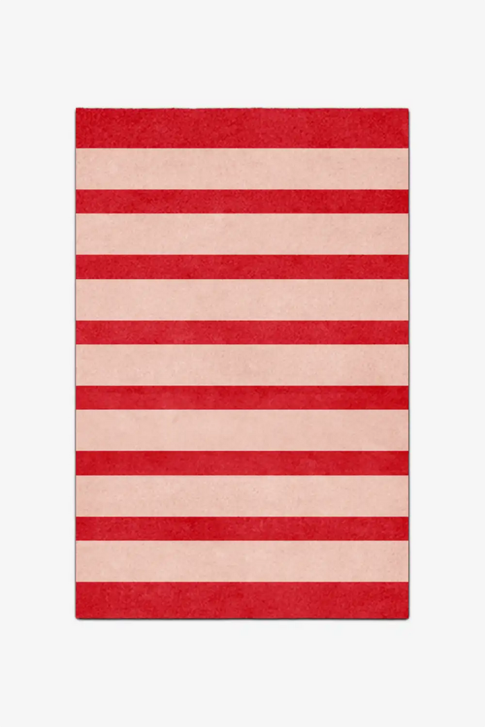 Striped red and beige rug on a white background