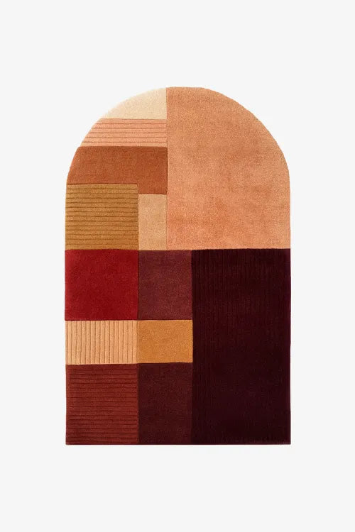 Geometric patterned rug with earthy tones on a white background