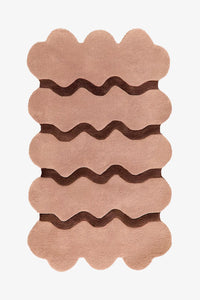 Neutral tan wool rug with dark brown ripple stripes, modern scalloped edge rug perfect for mid century living rooms