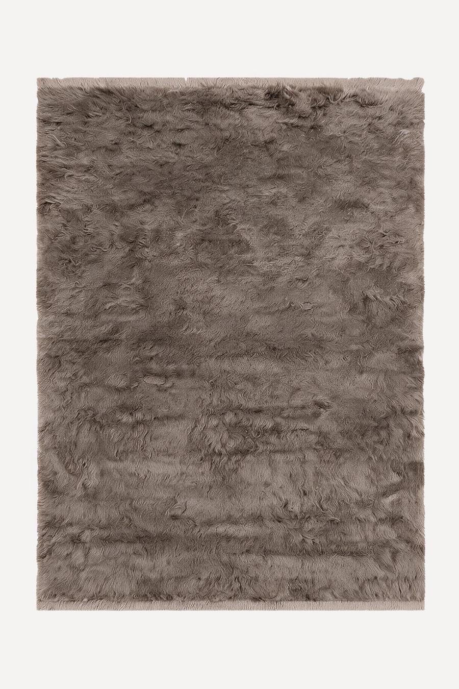 a taupe shag area rug with fringe ends