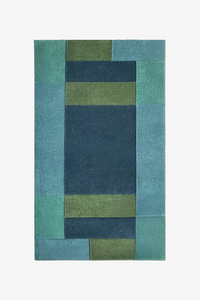 Rectangular rug with a geometric pattern in shades of blue and green on a white background