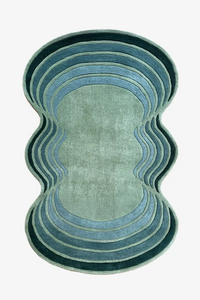 Rug with wavy, layered design in shades of blue on a white background