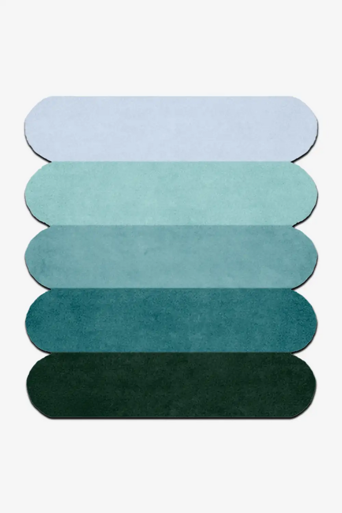 custom rug with light blue, teal and deep green scalloped sections for modern interiors