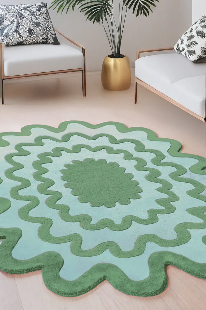 Tropical living room with a teal and blue scalloped wavy rug, neutral decor and minimalist furniture, organic contemporary style lifestyle