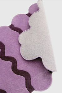 Mauve and plum purple ripple rug close-up showing soft tufted wool texture and durable cotton backing
