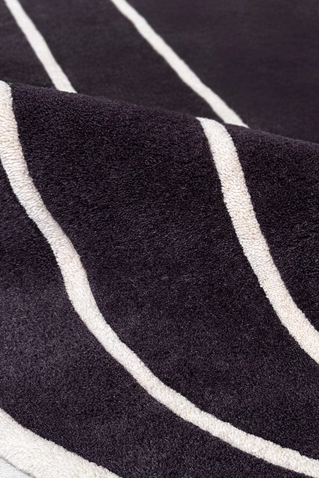 close up of black and white wool round rug