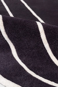 close up of black and white wool round rug