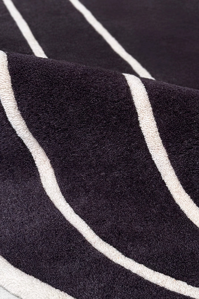 close up of black and white wool round rug