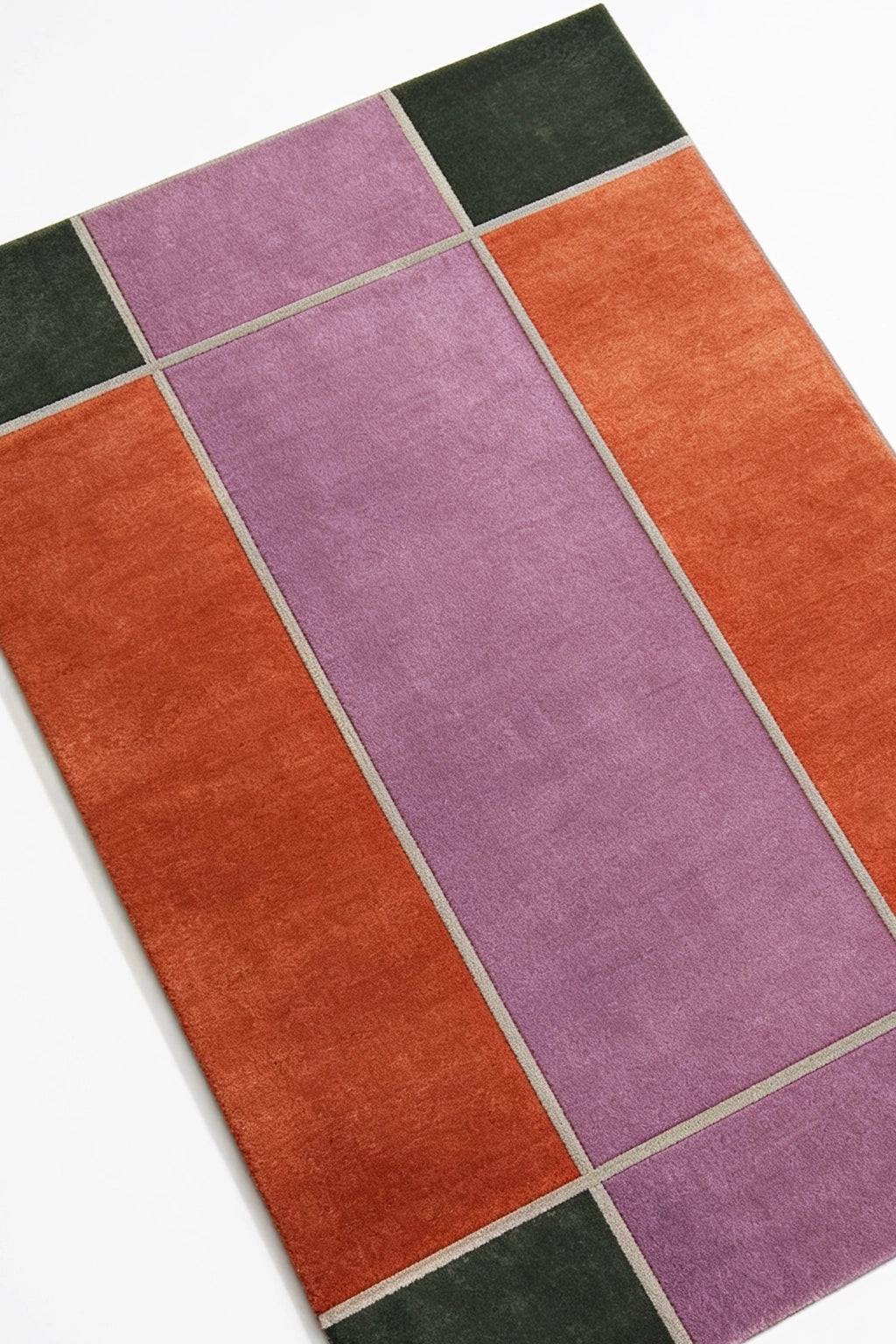 Colorful rectangular rug with purple, orange, and green sections on a white background