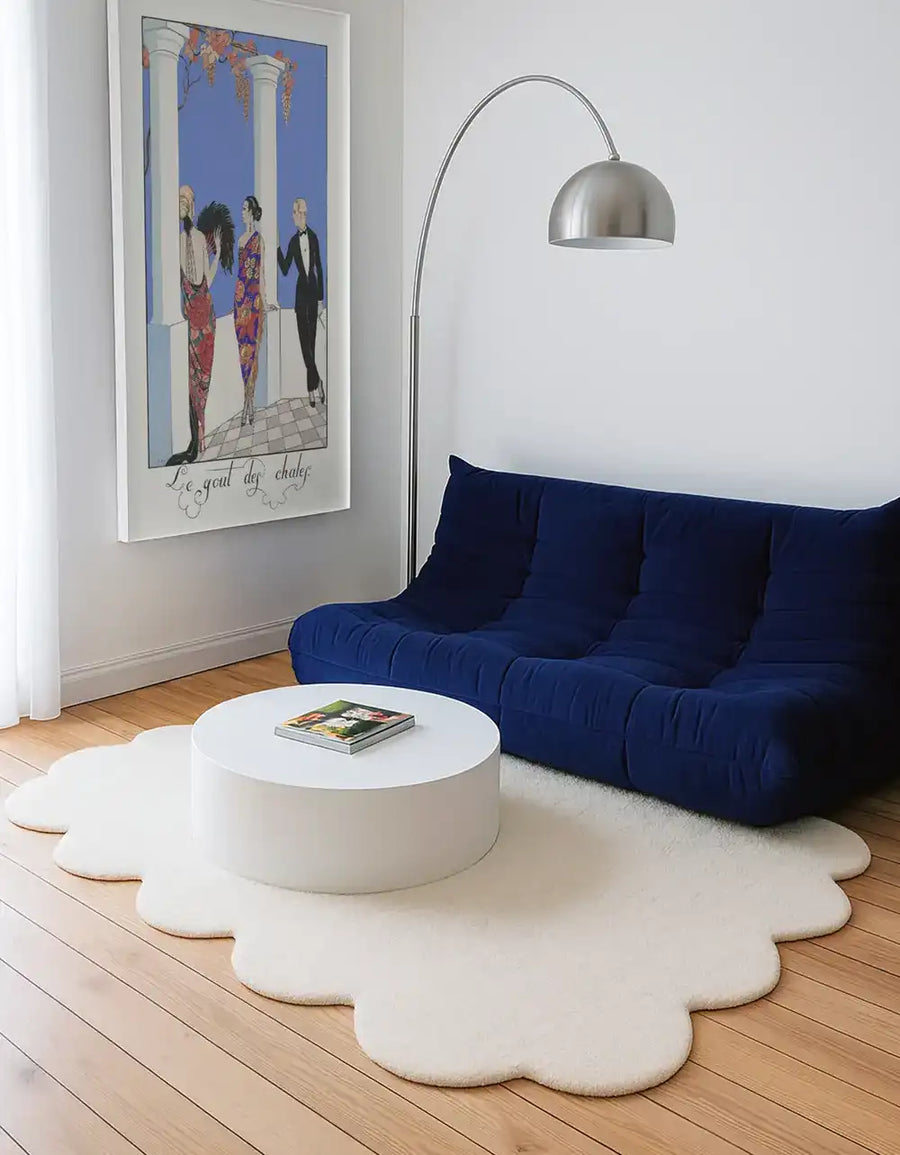 White modern sculptural rug placed under a blue velvet sofa, styled as a modern 8x10 rug or custom shaped rug for living rooms
