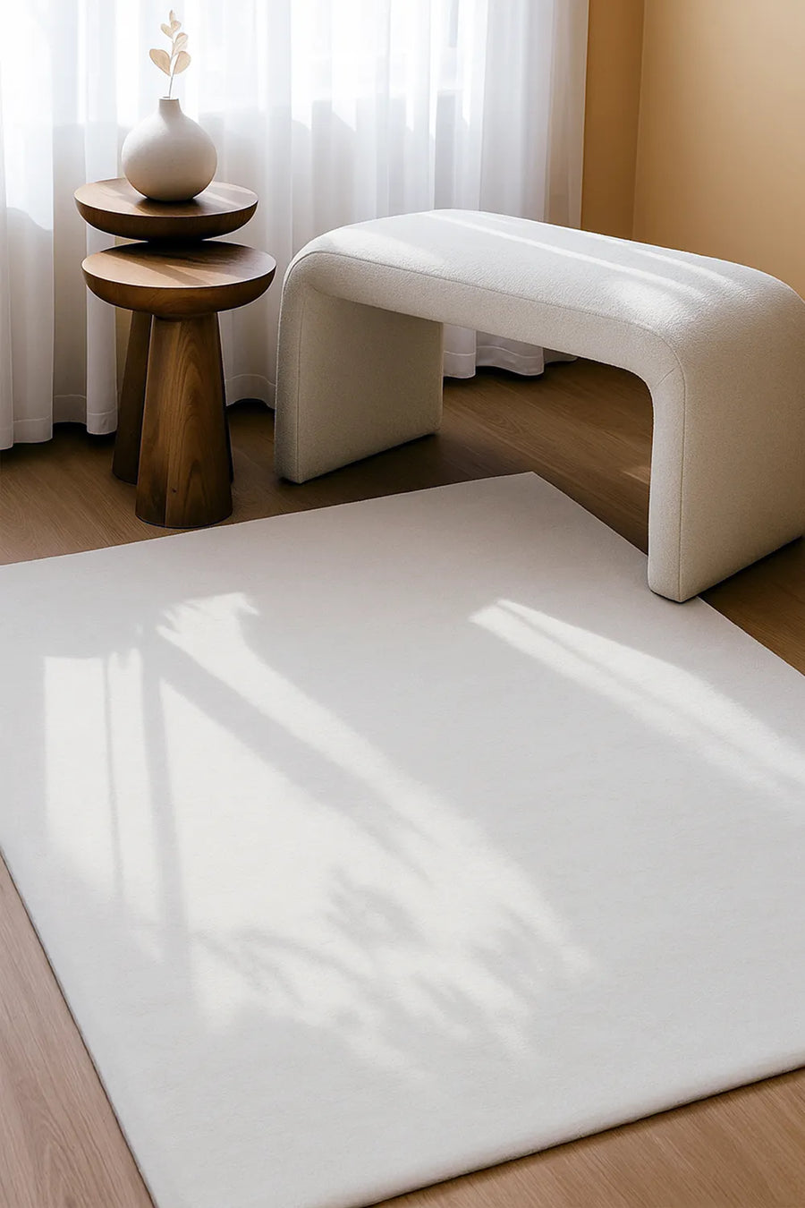Cream wool area rug in 6x9 size styled under bench seating, perfect for entryway rugs, office rugs, or minimalist spaces