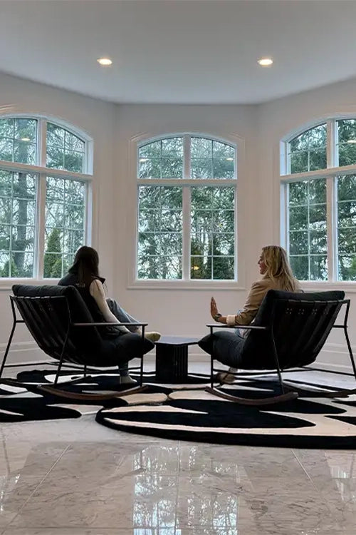 modern black and white zig zag rugs in a bright foyer