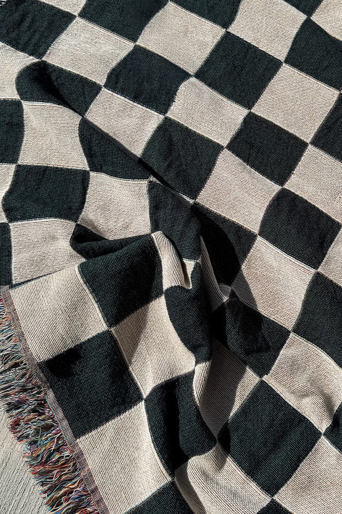 Classic black and white checkered blanket made from 100% cotton, a versatile modern throw for bed or sofa
