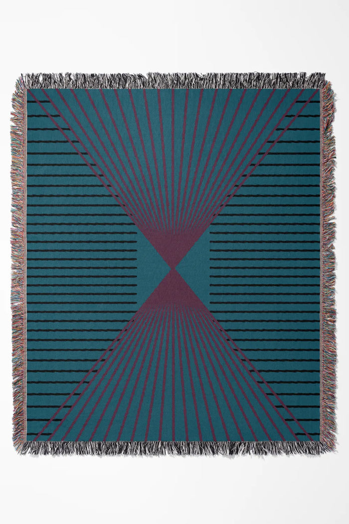 90s-style cotton woven throw blanket in teal, pink, and black with a geometric pattern.
