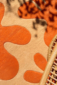 Hand-tufted 5x5 colorful wool rug with modern abstract design in bright orange lifestyle