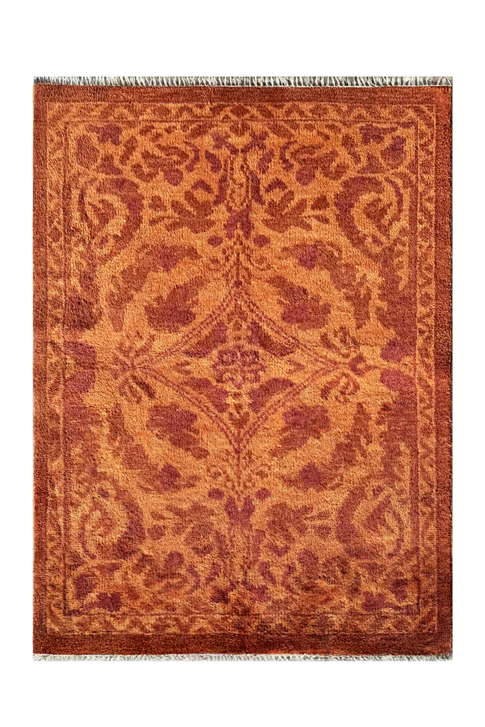 Hand-knotted wool rug with a floral vine pattern in terracotta and rust tones."