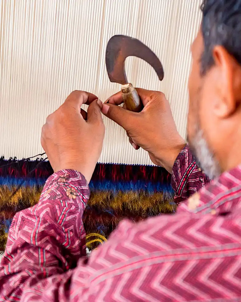 Close-up of an artisan handcrafting a custom rug, showcasing intricate design and craftsmanship