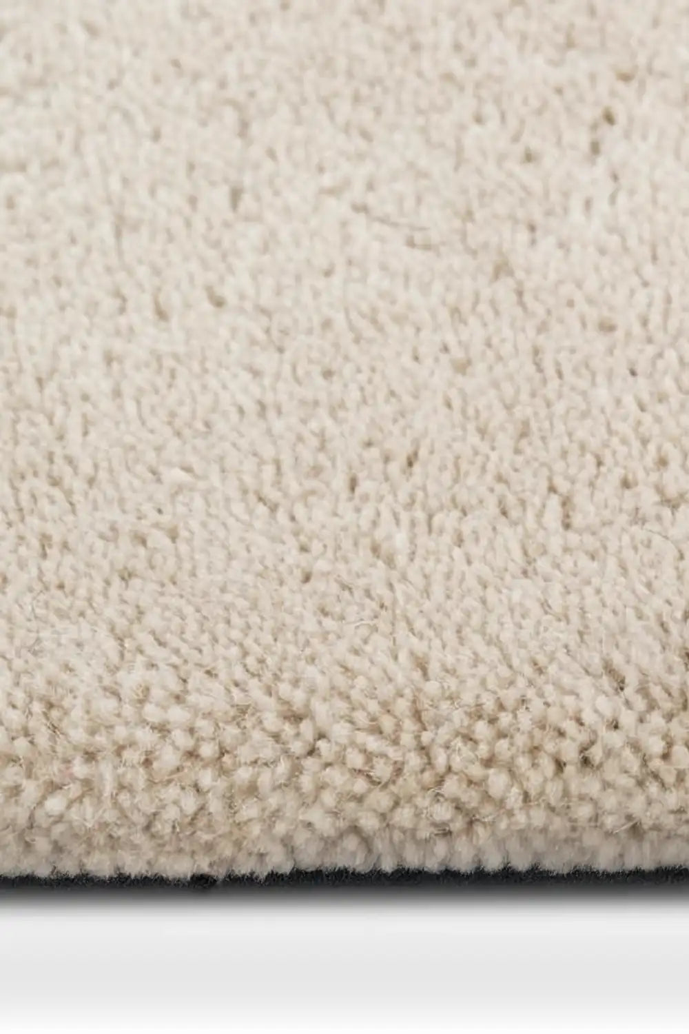 plush texture of a black and white plaid wool rug with a bold geometric pattern