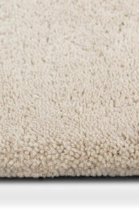 plush texture of a black and white plaid wool rug with a bold geometric pattern