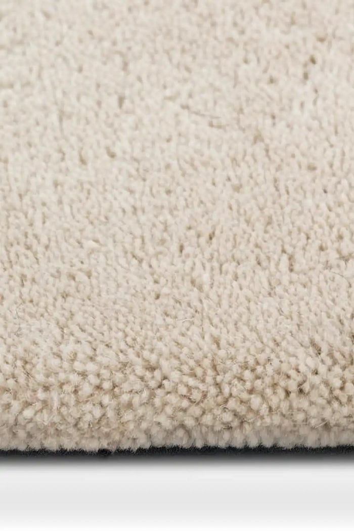 plush texture of a black and white plaid wool rug with a bold geometric pattern