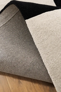 Black and cream area rug with sculpted zig-zag detailing